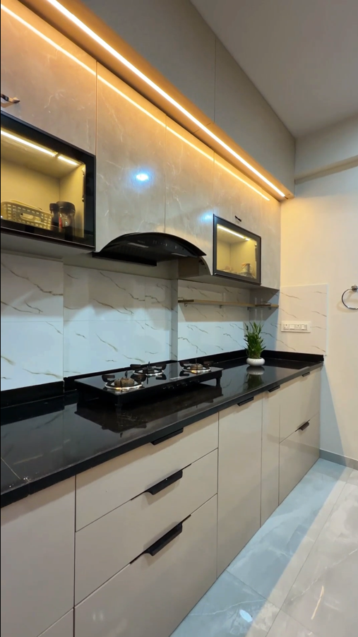 Modern handleless modular kitchen with marble backsplash