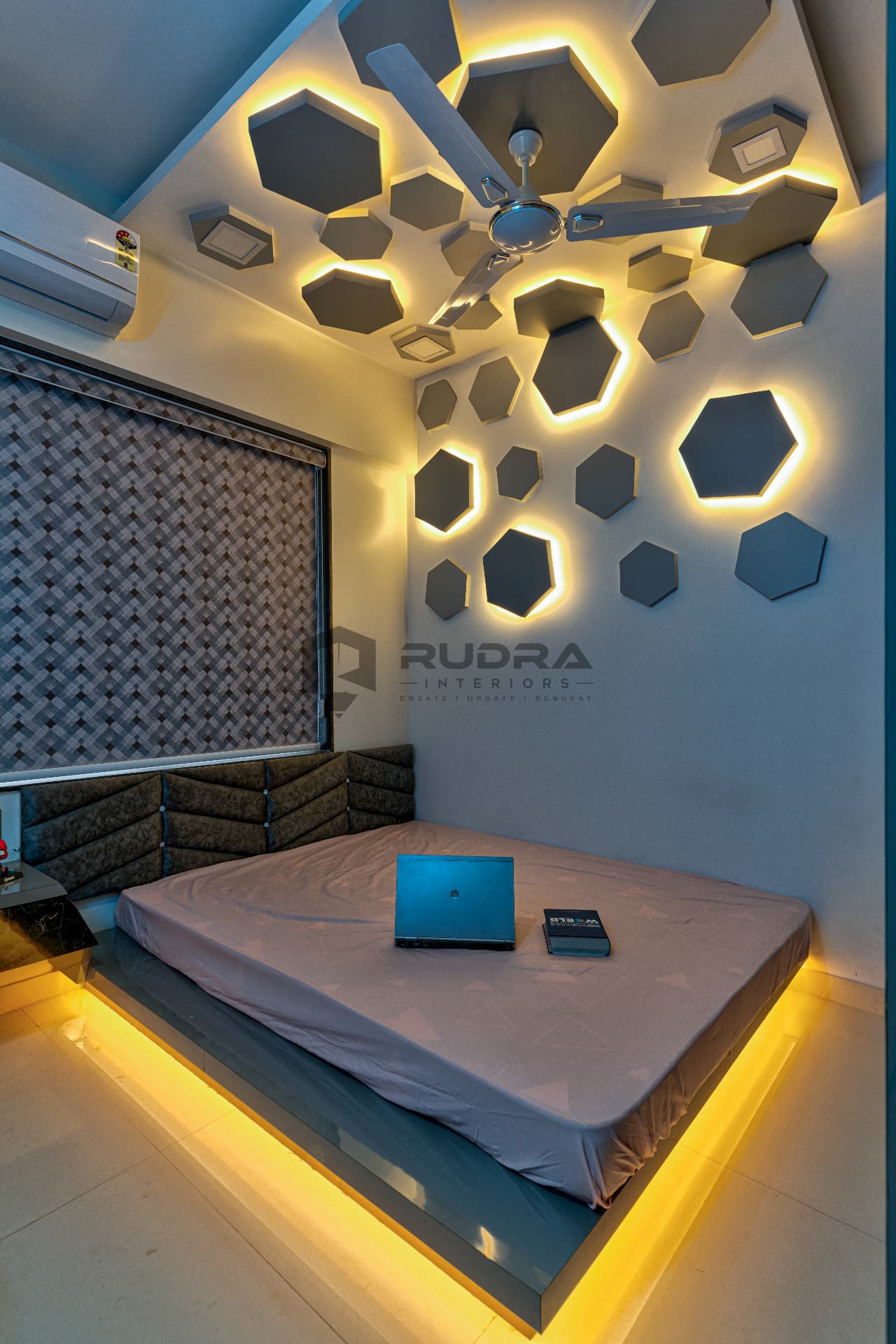 Hexagon backlit ceiling and platform bed in a modern bedroom